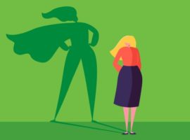 Woman standing in a dress, with a shadow of a superhero wearing a cape, representing professional bravery